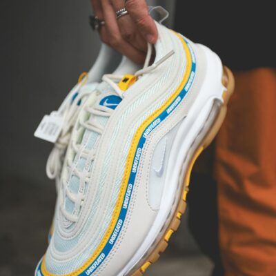 Close-up of a person holding a trendy Nike sneaker, perfect for fashion enthusiasts.