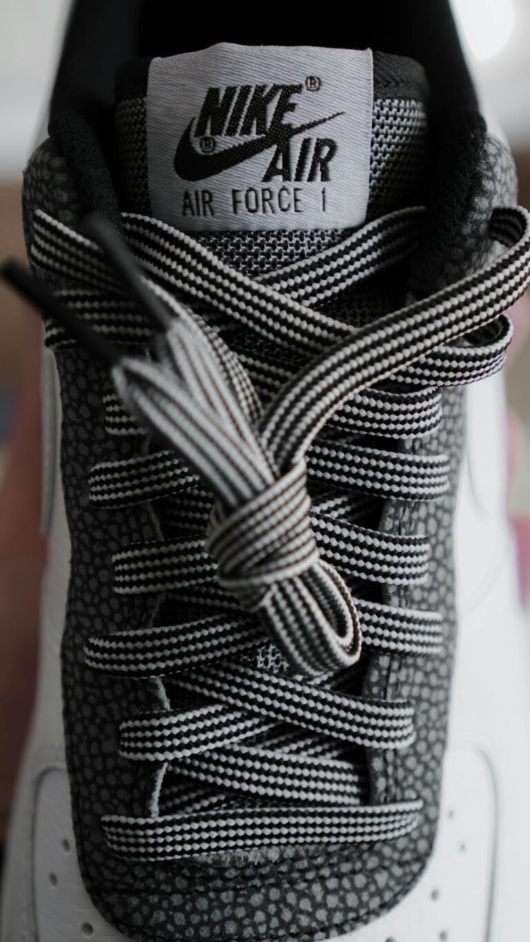 Detailed close-up shot of a modern black and white sneaker with unique textured design.