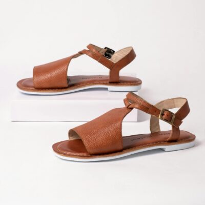 Set of elegant brown leather sandals displayed on a sleek white studio background.